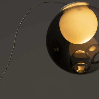 Captivating Bocci 28 single sculptural lamp with a glossy deep black exterior and milk white interior glass sphere