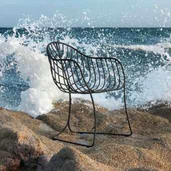 Elegant Royal Botania Folia armchair with a dark-toned metal frame and curvilinear silhouette crafted with a smooth matte finish